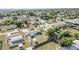 An aerial view shows a fenced backyard with a shed and nearby pool, highlighting the home's features at 3095 Pinetree St, Port Charlotte, FL 33952