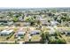 Aerial perspective of neighborhood showcasing street patterns, lush greenery, and proximity of homes to one another at 3095 Pinetree St, Port Charlotte, FL 33952