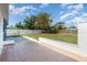 Expansive backyard with a concrete patio, grassy area, and a white fence, ideal for outdoor activities and relaxation at 3095 Pinetree St, Port Charlotte, FL 33952