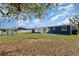 Spacious backyard featuring a shed, partial fence and grass lawn, perfect for outdoor activities and relaxation at 3095 Pinetree St, Port Charlotte, FL 33952