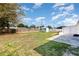 Expansive backyard with a storage shed, grassy area, and partial fencing, offering ample space and privacy at 3095 Pinetree St, Port Charlotte, FL 33952