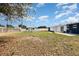 Large backyard featuring a shed, partial fence, and generous lawn space, ideal for outdoor recreation and storage at 3095 Pinetree St, Port Charlotte, FL 33952