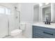 Modern bathroom with a glass-enclosed shower, a blue vanity, and a decorative mirror, providing a spa-like retreat at 3095 Pinetree St, Port Charlotte, FL 33952