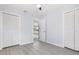 Open bedroom with light wood flooring, ceiling fan, closets and a door providing an entryway to the house at 3095 Pinetree St, Port Charlotte, FL 33952