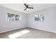 Airy bedroom with neutral walls, light wood flooring, and ample natural light from the two well-placed windows at 3095 Pinetree St, Port Charlotte, FL 33952