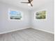 Bright bedroom with neutral walls, wood flooring, and two windows, providing ample natural light and a calming atmosphere at 3095 Pinetree St, Port Charlotte, FL 33952