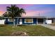 Charming curb appeal with well-maintained lawn and blue exterior on this cozy single-Gathering home at 3095 Pinetree St, Port Charlotte, FL 33952