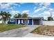 Charming curb appeal with well-maintained lawn and blue exterior on this cozy single-Gathering home at 3095 Pinetree St, Port Charlotte, FL 33952
