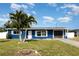Charming curb appeal with well-maintained lawn and blue exterior on this cozy single-Gathering home at 3095 Pinetree St, Port Charlotte, FL 33952