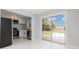 Open kitchen featuring stainless steel appliances and sliding glass doors leading to the backyard at 3095 Pinetree St, Port Charlotte, FL 33952