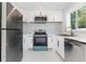 Modern kitchen with stainless steel appliances, white cabinets, and sleek countertops, creating a clean and functional space at 3095 Pinetree St, Port Charlotte, FL 33952