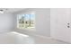 Bright living room featuring a large window and neutral paint; ready for your personal touches at 3095 Pinetree St, Port Charlotte, FL 33952