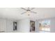 Open-concept living room with neutral paint and sliding glass doors leading to the backyard at 3095 Pinetree St, Port Charlotte, FL 33952