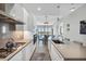 Modern kitchen featuring sleek white cabinetry and stainless steel appliances, open to dining and living areas at 33 S Palm Ave # 1403, Sarasota, FL 34236