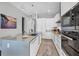 Sleek, modern kitchen with gray countertops, white cabinetry, stainless steel appliances, and bar seating at 33 S Palm Ave # 1403, Sarasota, FL 34236