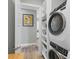 Modern laundry room with high-end washer and dryer units, along with storage shelves at 33 S Palm Ave # 1403, Sarasota, FL 34236