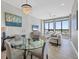 Bright and spacious living area with expansive windows, chandelier, open to dining area at 33 S Palm Ave # 1403, Sarasota, FL 34236