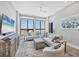 Bright living room features large windows with expansive views, neutral decor, and comfortable seating at 33 S Palm Ave # 1403, Sarasota, FL 34236
