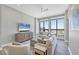 Bright living room features large windows with expansive views, neutral decor, and comfortable seating at 33 S Palm Ave # 1403, Sarasota, FL 34236