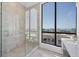 Modern bathroom features a glass shower with a view from the large window at 33 S Palm Ave # 1702, Sarasota, FL 34236