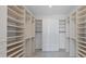 Bright walk-in closet featuring custom shelving and storage solutions with marble floors at 33 S Palm Ave # 1702, Sarasota, FL 34236