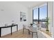 Bright dining area featuring a modern table and a large window with stunning city views at 33 S Palm Ave # 1702, Sarasota, FL 34236