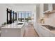 Bright kitchen with white cabinets, an island, and floor-to-ceiling windows offering city views at 33 S Palm Ave # 1702, Sarasota, FL 34236