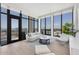 Bright living room featuring floor-to-ceiling windows and modern furnishings at 33 S Palm Ave # 1702, Sarasota, FL 34236