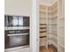 Pantry and oven with wooden shelves for organized storage at 33 S Palm Ave # 1702, Sarasota, FL 34236