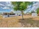 Expansive backyard featuring a lush tree, storage shed, and ample space for outdoor activities and relaxation at 3599 Bali Dr, Sarasota, FL 34232