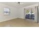 Bright bedroom with ceiling fan and sliding door leading to the screened-in patio at 3599 Bali Dr, Sarasota, FL 34232