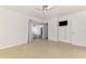 Bedroom with ceiling fan and sliding glass door that leads to an enclosed patio at 3599 Bali Dr, Sarasota, FL 34232