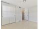 Bright bedroom featuring a ceiling fan, closet, and an ensuite bathroom at 3599 Bali Dr, Sarasota, FL 34232
