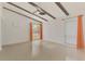 Bright, airy bedroom with beamed ceiling, sleek flooring and natural light from large windows at 3599 Bali Dr, Sarasota, FL 34232