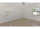 Well-lit bedroom with ceiling fan and windows providing natural light at 3599 Bali Dr, Sarasota, FL 34232