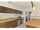 Charming kitchen featuring a stainless steel oven and dark cabinets at 3599 Bali Dr, Sarasota, FL 34232