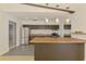 Galley kitchen featuring stainless steel appliances, pendant lighting, and brown cabinets at 3599 Bali Dr, Sarasota, FL 34232