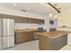 Bright kitchen with stainless steel appliances and island counter at 3599 Bali Dr, Sarasota, FL 34232