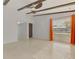 Well-lit room featuring beamed ceilings, sleek flooring, and large windows at 3599 Bali Dr, Sarasota, FL 34232