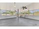 Spacious sunroom featuring multiple ceiling fans, and a metal gate at 3599 Bali Dr, Sarasota, FL 34232