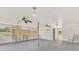 Large sunroom featuring multiple ceiling fans, and a metal gate at 3599 Bali Dr, Sarasota, FL 34232