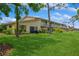 Spacious backyard with lush green lawn, mature trees, and multi-Gathering unit at 3610 54Th W St # B4, Bradenton, FL 34209