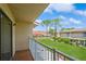Balcony view of the green lawn and neighboring buildings under a blue sky at 3610 54Th W St # B4, Bradenton, FL 34209