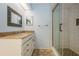 Bathroom featuring vanity and updated walk-in shower with glass doors at 3610 54Th W St # B4, Bradenton, FL 34209
