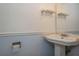 Bathroom featuring a vintage pedestal sink with chrome faucet, mirror, and toilet paper holder at 3610 54Th W St # B4, Bradenton, FL 34209