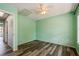 Bright green bedroom featuring hardwood floors and a ceiling fan at 3610 54Th W St # B4, Bradenton, FL 34209