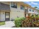 Inviting townhouse exterior with tan siding, front door, manicured bushes, and a small front yard at 3610 54Th W St # B4, Bradenton, FL 34209