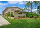 Townhouse exterior featuring well-manicured lawn, exterior stucco, and manicured landscaping at 3610 54Th W St # B4, Bradenton, FL 34209