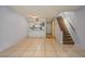 Open-concept living room featuring tile flooring, staircase, and eat-in kitchen with stainless steel appliances at 3610 54Th W St # B4, Bradenton, FL 34209