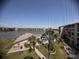 View of the community pool and lush landscaping from the screened balcony at 3647 Lake Bayshore Dr # 416, Bradenton, FL 34205